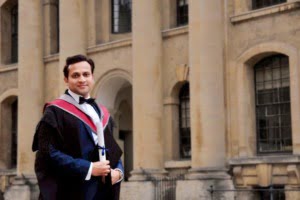 Tarak Nath Gorai standing with his graduation degree in from of Oxford University on Graduation Day, Oxford MBA
